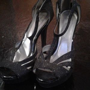 Shimmery black high heels.